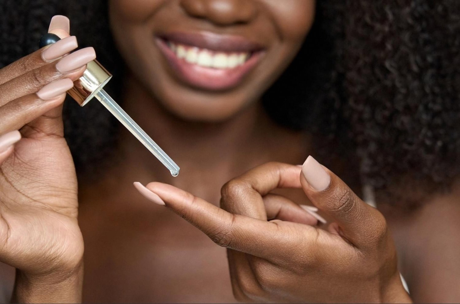 Woman applying a brightening serum with a dropper for melasma treatment